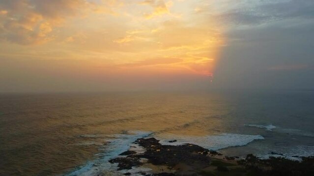 Aerial view from above of the sunset of the sea sandy shore. Ocean coast. Calm beautiful video on the background for tourism, design and advertising