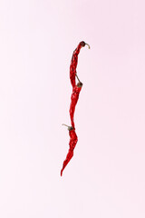 Red peppers on a pink background. Creative food concept.