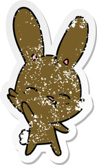 distressed sticker of a curious waving bunny cartoon