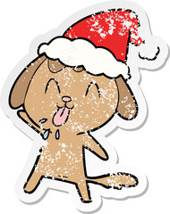 cute distressed sticker cartoon of a dog wearing santa hat