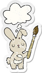 cartoon rabbit with paint brush and thought bubble as a distressed worn sticker