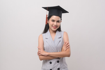 Young smiling woman wearing graduation hat, education and university concept.