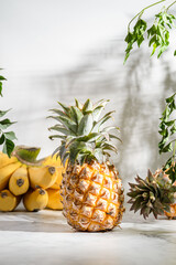pineapple and bananas on a light table