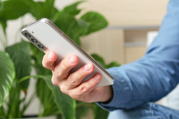 Male hands typing text message on mobile phone, social media concept