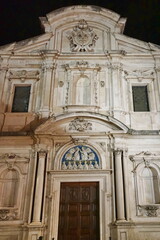 Fototapeta na wymiar Facade of Ognissanti church at night in Florence, Tuscany, Italy