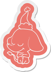 cartoon  sticker of a smiling elephant wearing santa hat
