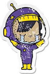 distressed sticker of a cartoon crying astronaut girl