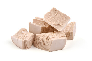 Fresh yeast cube, isolated on white background.