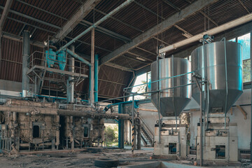 Fototapeta premium interiors and machinery, plants retaking possession of a disused abandoned industry, former cotton mill, industrial production