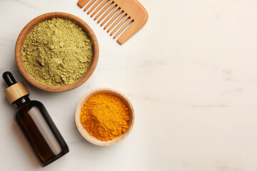 Comb, bottle, henna and turmeric powder on white marble table, flat lay. Space for text