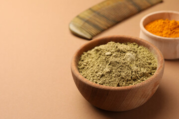 Henna and turmeric powder on beige background, closeup with space for text. Natural hair coloring