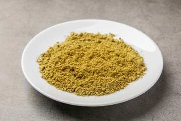 Henna powder on grey background. Natural hair coloring