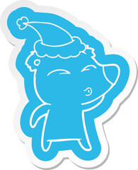 cartoon  sticker of a whistling bear wearing santa hat