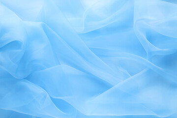 Beautiful light blue tulle fabric as background, closeup