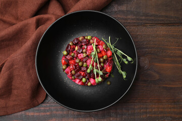 Delicious vinaigrette salad on wooden table, flat lay