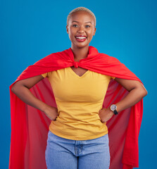 Black woman, superhero cape and portrait in studio, blue background and fashion. Happy female...
