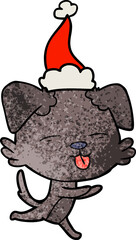 textured cartoon of a dog sticking out tongue wearing santa hat