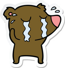 sticker of a cartoon crying bear