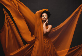 Black woman, art and fashion, flowing fabric on dark background with beauty and aesthetic movement....