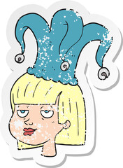 retro distressed sticker of a cartoon woman wearing jester hat