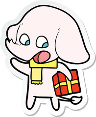 sticker of a cute cartoon elephant with christmas present