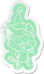cartoon distressed sticker of a nervous cat wearing santa hat