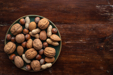 bowl of nuts on a wooden background