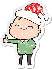 happy distressed sticker cartoon of a bald man wearing santa hat