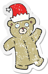 retro distressed sticker of a cartoon teddy bear wearing christmas hat