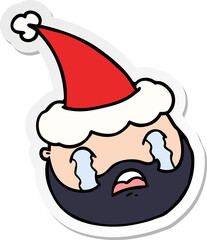 sticker cartoon of a male face with beard wearing santa hat