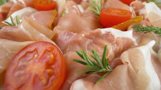 Raw ham. Slices of pork dried ham. Italian cold cuts, prosciutto crudo. Close up shot