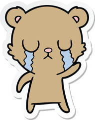 sticker of a crying cartoon bear
