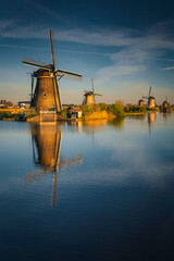 Fototapeta na wymiar Morning among the windmills in Kinderdijk - one of the most characteristic places in the Netherlands. The beautiful spring adds charm to this place.