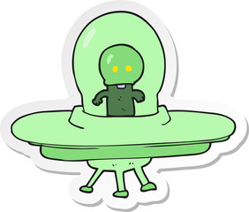 sticker of a cartoon alien in flying saucer