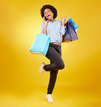 Shopping Bag, Excited Phone Call And Portrait Black Woman With Sales Product, Discount Fashion Deal Or Mall Store Present. Talking, Designer Gift And Happy Customer Chat Isolated On Yellow Background