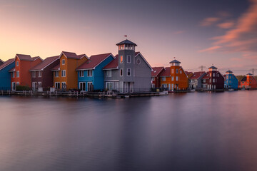 Colorful houses in Groningen during the blue hour. The original architecture of the houses is a...
