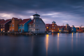 Colorful houses in Groningen during the blue hour. The original architecture of the houses is a...