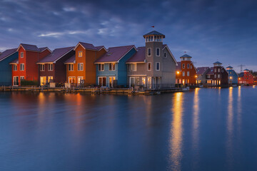 Colorful houses in Groningen during the blue hour. The original architecture of the houses is a...