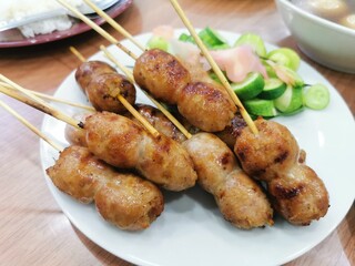 Delicious Thai esan sausage with cucumber and ginger it's popular Thai steet foods.