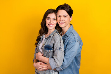 Portrait of idyllic cheerful partners cuddle hug toothy smile good mood isolated on yellow color background