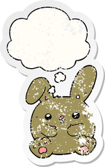 cartoon rabbit and thought bubble as a distressed worn sticker