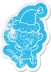 cartoon distressed sticker of a surprised monkey wearing santa hat