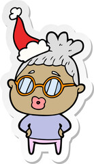 sticker cartoon of a librarian woman wearing spectacles wearing santa hat