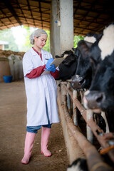 Farmers are recording details of each cow on the farm.