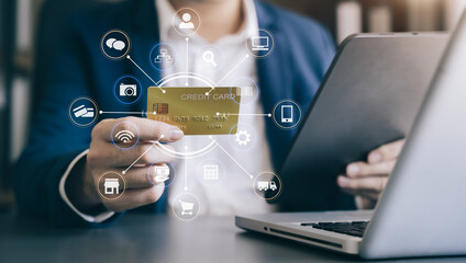 Male businessman use credit cards to conduct financial transactions through phones.