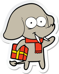 sticker of a happy cartoon elephant with present