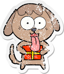 distressed sticker of a cute cartoon dog with christmas present