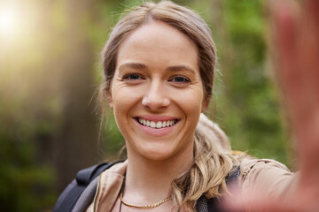 Naklejka premium Hiking, selfie or girl in nature, forest or wilderness live streaming online trekking adventure. Face pictures, social media vlogger or hiker walking in woods for exercise or wellness on holiday