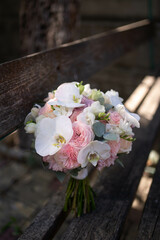 The bride holds a wedding bouquet of white orchids. Wedding decor ideas