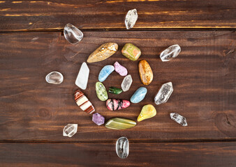 Colorful healing crystal stones, gemstones in happy spiral shape. Alternative therapy, chakra energy, reiki or spiritual background. Positivity.
